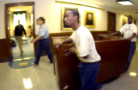 US Navy 031113-N-9693M-007 Office Mover employees wheel the Secretary of the Navy's desk