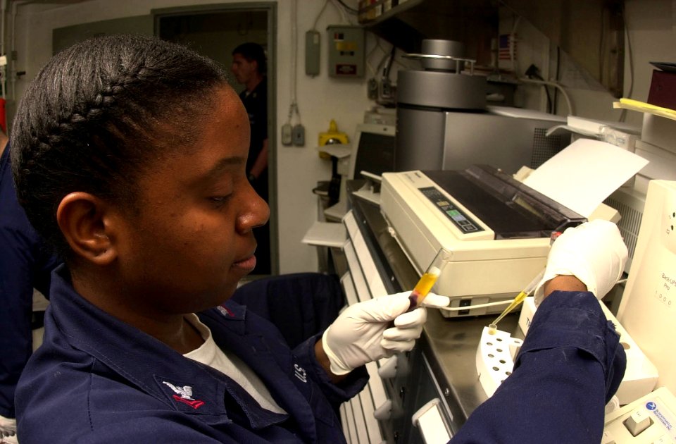US Navy 030923-N-1577S-003 Hospital Corpsman 2nd Class Donna Sanderson from Lancaster, Calif., prepares serum cups