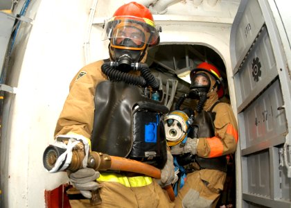 US Navy 030930-N-8955H-009 Mess Management Specialist Seaman Apprentice Matthew Jacobs, from Salt Lake City, Utah, and Journalist 3rd Class Seth Bauer, from Peoria, Ariz., enter the ship's boat shop