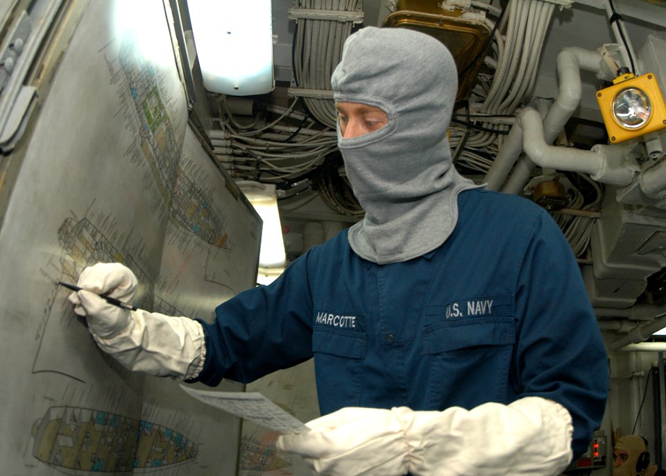 US Navy 030930-N-8955H-007 Maintenance Technician 2nd Class Joseph Marcotte, from Loveland, Colo., updates the Damage Control Central status board