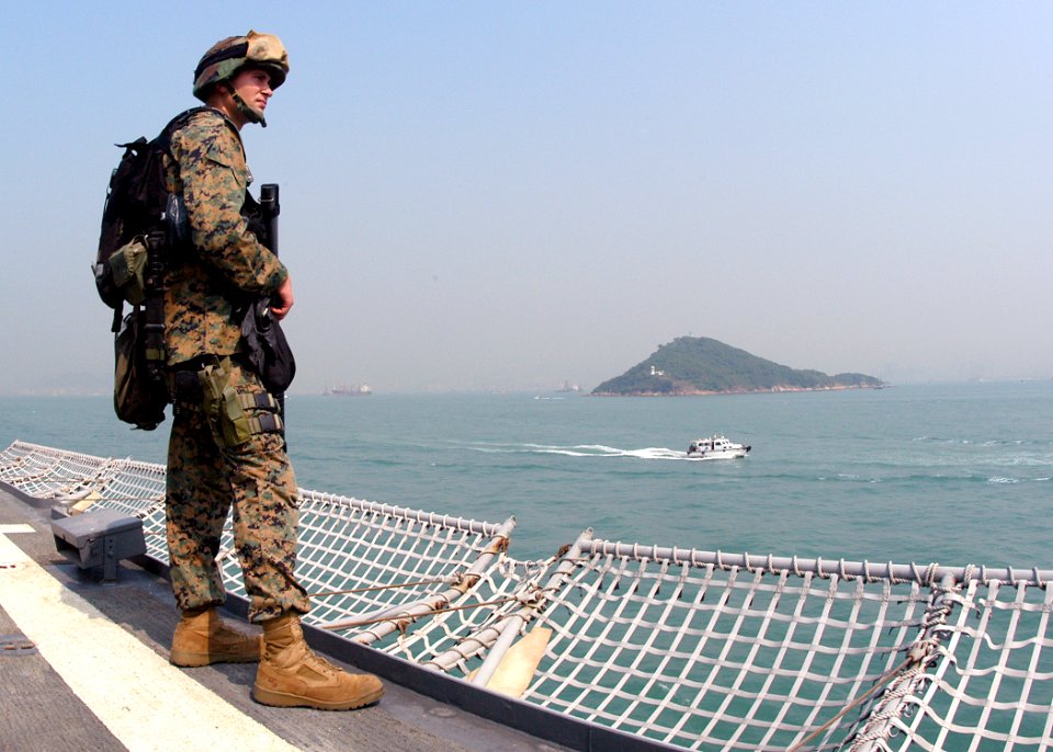 US Navy 031101-N-8955H-003 Marine Lance Cpl. Mike Anderson, from Modesto, Calif., closely watches vessels in Hong Kong harbor as USS Blue Ridge (LCC 19) departs following a four-day port call