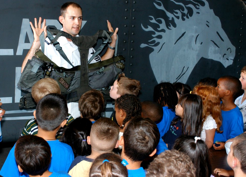 US Navy 031003-N-5821W-004 Aircrew Survival Equipmentman 1st Class Ryan Fitzgerald shows a group of first-grade students survival equipment