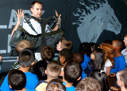US Navy 031003-N-5821W-004 Aircrew Survival Equipmentman 1st Class Ryan Fitzgerald shows a group of first-grade students survival equipment