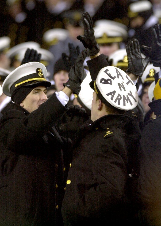US Navy 031206-N-9693M-519 U.S. Naval Academy Midshipmen high-five each other to celebrate a Navy play during the 104th Army Navy game