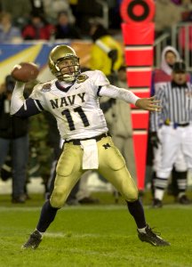 US Navy 031206-N-9693M-511 Navy quarterback Craig Candeto looks for a receiver downfield during the 104th Army Navy Game photo