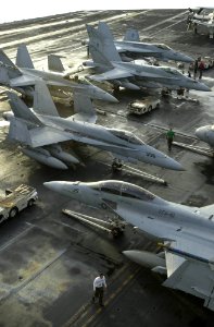 US Navy 030930-N-9319H-005 On the flight deck aboard USS Nimitz (CVN 68) crew members prepare F-A-18 Hornets for morning flight operations