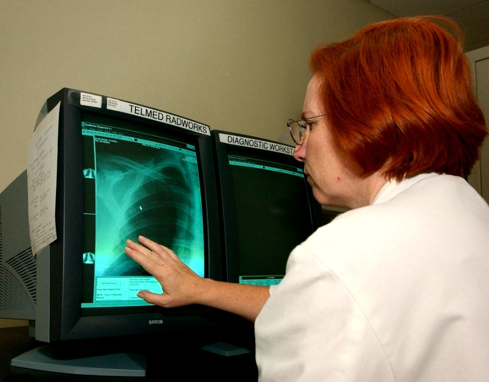 US Navy 030820-N-9593R-046 Cmdr. (MC) Sharon Marshall studies an x-ray from the fleet at the National Naval Medical Center in Bethesda, Maryland