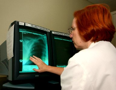 US Navy 030820-N-9593R-046 Cmdr. (MC) Sharon Marshall studies an x-ray from the fleet at the National Naval Medical Center in Bethesda, Maryland