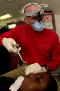 US Navy 031002-N-1577S-007 Oral Surgeon Capt. John Le Banc of Hillsburrow, Ill., removes a wisdom tooth