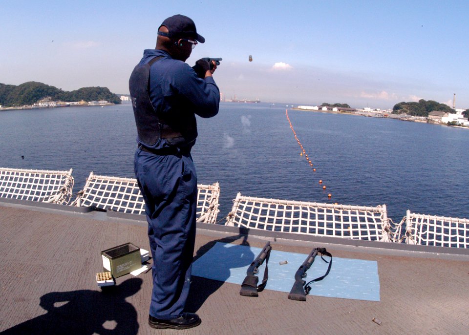 US Navy 030918-N-8955H-010 Master-at-Arms 2nd Class Quincy Jackson from Athens, Ga., shoots a non-lethal airburst device