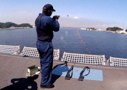 US Navy 030918-N-8955H-010 Master-at-Arms 2nd Class Quincy Jackson from Athens, Ga., shoots a non-lethal airburst device