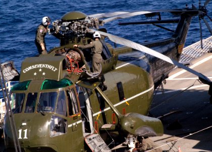 US Navy 031025-N-8955H-006 Airmen assigned to the War Lords of Light Helicopter Anti-Submarine Squadron Fifty One (HSL-51), conduct maintenance on the Commander, Seventh Fleet helicopter aboard USS Blue Ridge (LCC 19)