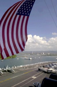 US Navy 031027-N-2385R-008 Crewmembers aboard USS Nimitz (CVN 68) and embarked Carrier Air Wing Eleven (CVW-11), man the rails while passing by the USS Arizona Memorial upon entering Pearl Harbor, Hawaii