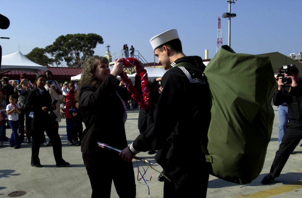 US Navy 031105-N-9319H-002 Machinist's Mate 2nd Class Barry Varnell greets his wife during the homecoming festivities for USS Nimitz (CVN 68)