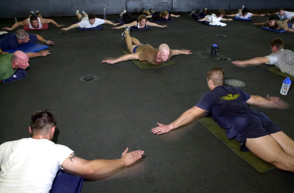 US Navy 030925-N-6536T-002 Gunner's Mate 3rd Class Dave Hawley leads crewmembers in calisthenics