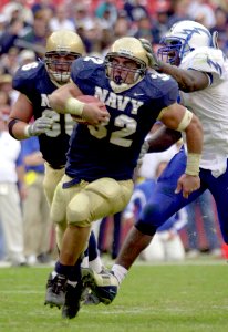 US Navy 031004-N-9693M-011 Navy fullback Kyle Eckel outpaces Air Force linebacker Marchello Graddy for yardage