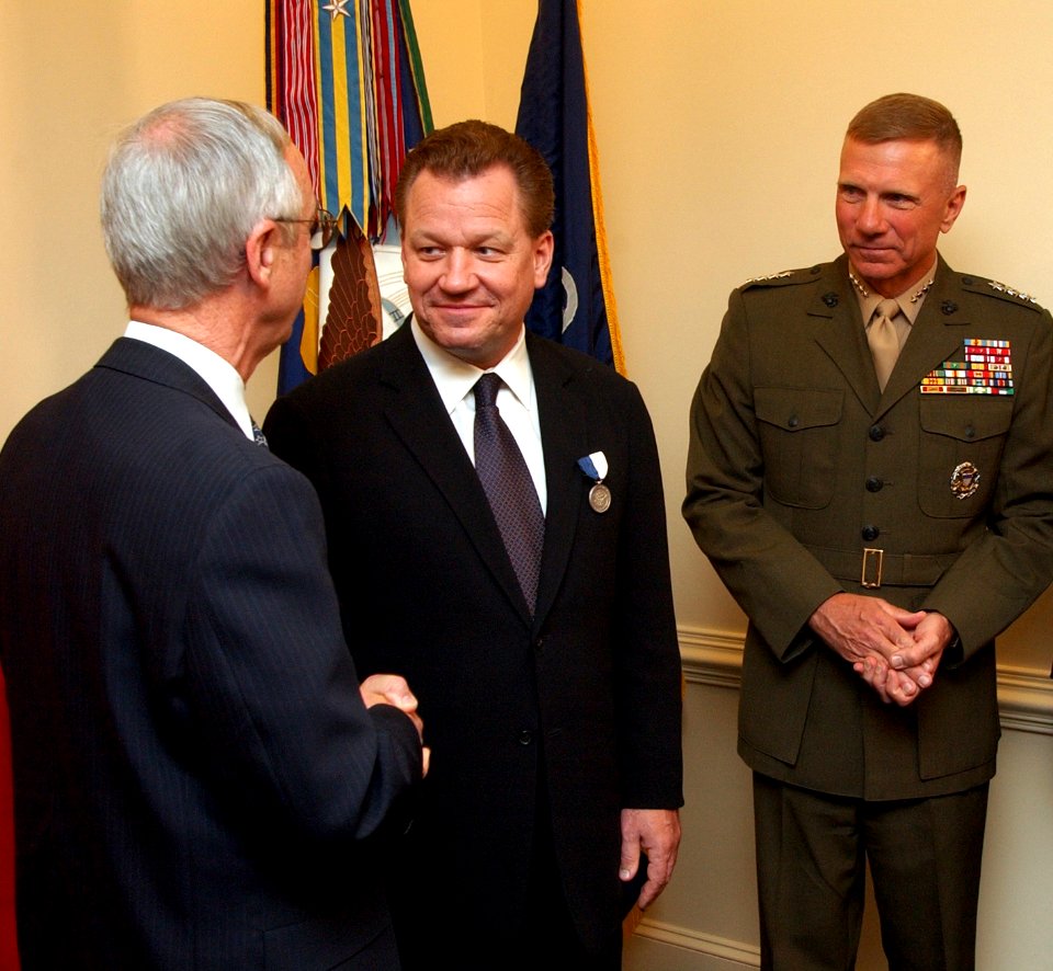 US Navy 031118-N-2568S-003 Secretary of the Navy Gordon R. England presents author James Bradley the Department of the Navy Superior Public Service Award for his contributions in keeping alive the history of the Navy and Marine