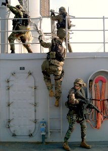 US Navy 031018-N-1693W-002 The 2nd Fleet Anti-Terrorism Team (FAST), 7th Platoon, provides cover for fellow Marines as they take up positions aboard USS Blue Ridge (LCC 19) during a mock anti-terrorism boarding exercise