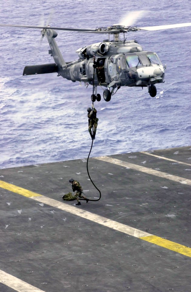 US Navy 031017-N-2143T-002 Explosive Ordinance Disposal Mobile Unit Eleven Detachment One (EOD MU11 DET 1) fast ropes out of a HH-60H Seahawk
