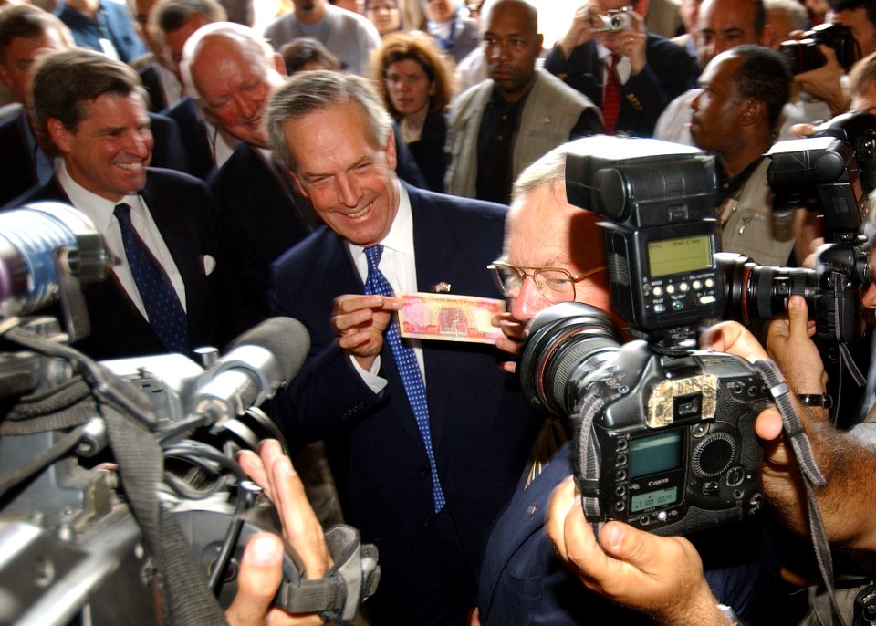 US Navy 031015-N-4374S-007 U.S. Secretary of Commerce Don Evans displays a new Iraqi diner during a press conference