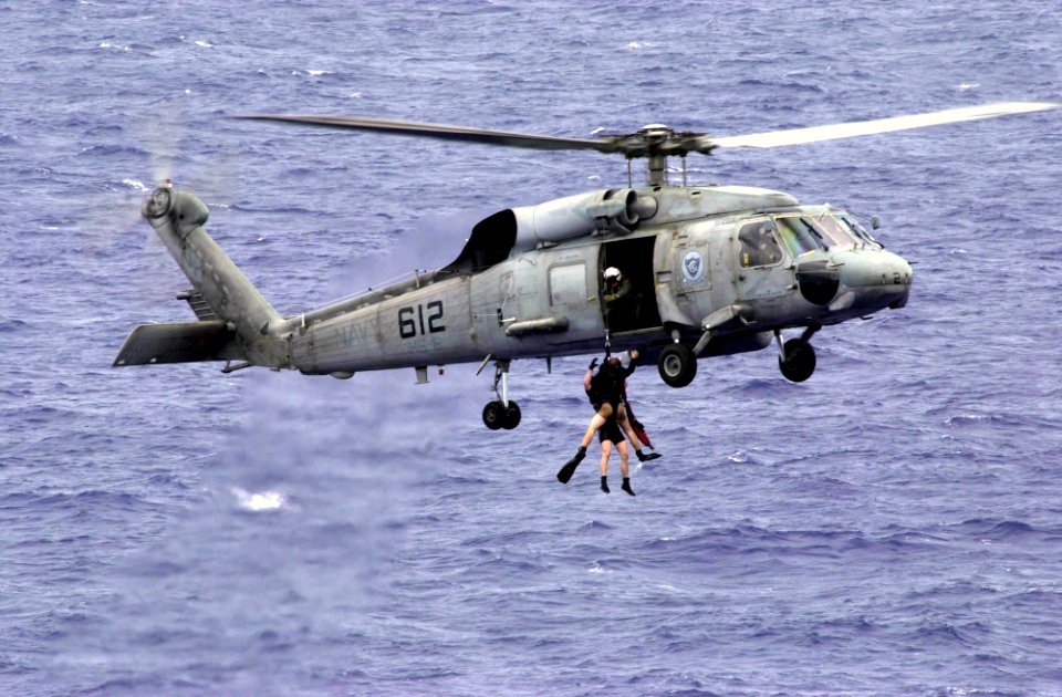 US Navy 031017-N-1577S-003 An SH-60F Seahawk assigned to the Indians of Helicopter Anti-Submarine Squadron Six (HS-6) recover Search and Rescue (SAR) swimmers