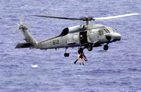 US Navy 031017-N-1577S-003 An SH-60F Seahawk assigned to the Indians of Helicopter Anti-Submarine Squadron Six (HS-6) recover Search and Rescue (SAR) swimmers