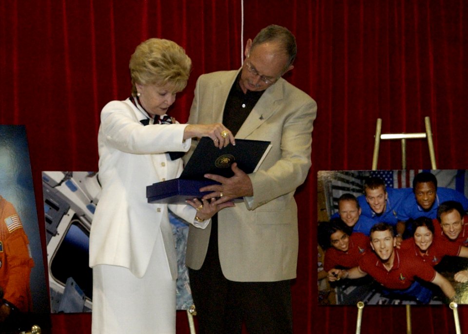 US Navy 030829-N-7293M-033 The Honorable Madeleine Z. Bordallo, Guam's delegate to the U.S. House of Representatives, presents a flag that was flown over the U.S. Capitol on 1 February 2003 to Mr. William A. Hall