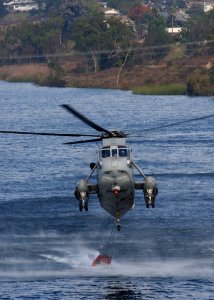 US Navy 031029-N-5067K-109 A UH-3H Sea King helicopter loads its Bambi bucket