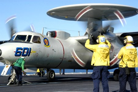 US Navy 031017-N-6278K-003 Aviation Boatswain's Mate 3rd Class Wycherley St Aimie, of Bronx, N.Y., makes the final checks on an E-2C Hawkeye