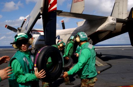 US Navy 031018-N-5821P-006 Storekeeper 3rd Class Jonathan E. Crismond of Camden, N.J., works to off-load cargo from a C-2A Greyhound aboard USS Kitty Hawk (CV 63)