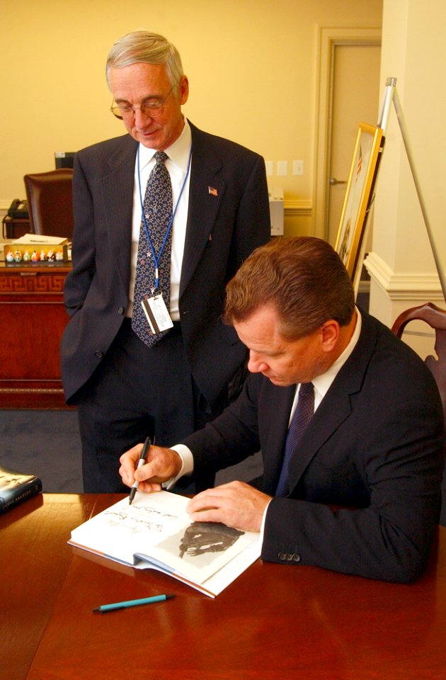 US Navy 031118-N-2568S-005 Best-selling author James Bradley signs a copy of his book for Secretary of the Navy Gordon R. England
