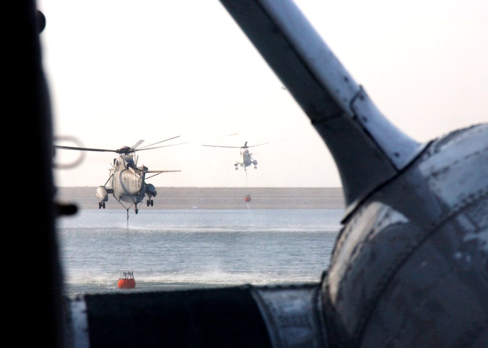 US Navy 031029-N-5067K-099 Two Sea King helicopters load their Bambi buckets