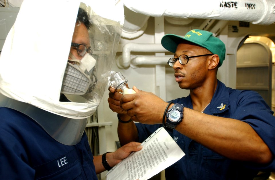 US Navy 031202-N-5821P-001 Boatswain's Mate 2nd Class Mark Williams of Rochester, N.Y., conducts fit testing