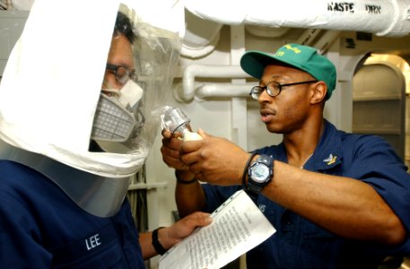 US Navy 031202-N-5821P-001 Boatswain's Mate 2nd Class Mark Williams of Rochester, N.Y., conducts fit testing