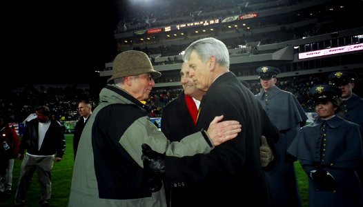 US Navy 031206-N-2568S-015 Secretary of the Navy, Gordon R. England meets Acting Secretary of the Army Les Brownlee and Secretary of Veterans Affairs Anthony J. Principi in the middle of the field at halftime of the 104th Army