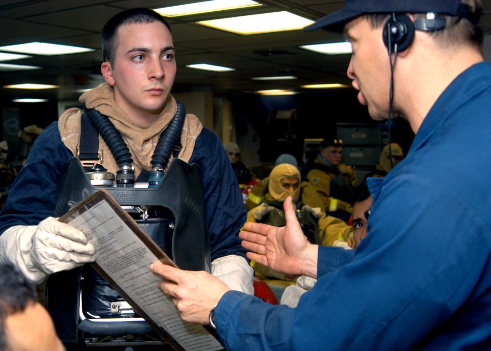 US Navy 031015-N-8955H-004 Lt. Cmdr. Michael Curtis from Congview, Wash., briefs Hull Maintenance Technician Fireman Jacob Styron