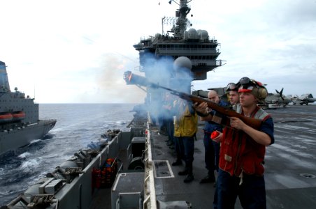 US Navy 031103-N-5821P-003 Aviation Ordnanceman Airman Ralph Jones, from Detroit, Mich., fires a shot line to USNS Yukon (T AO 202)