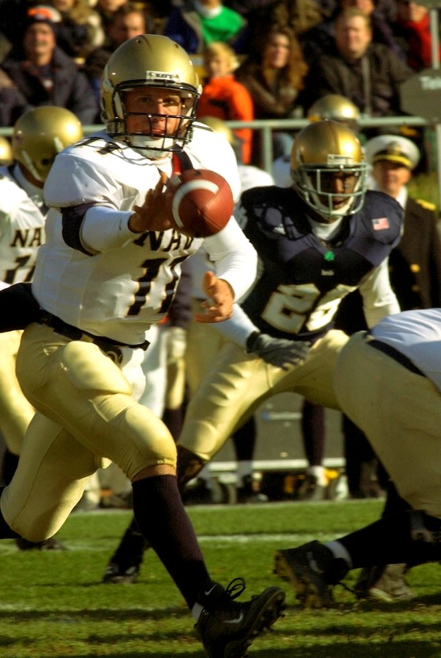 US Navy 031108-N-9593R-011 Navy quarterback Craig Candeto pitches the ball out