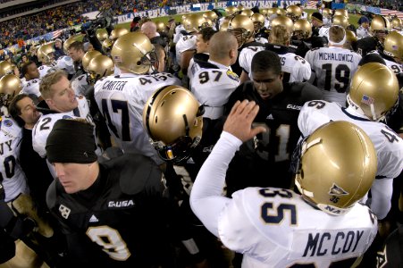 US Navy 031206-N-0399H-527 Army and Navy football players meet in the center of the field to congratulate each other on a good game following the Army Navy game