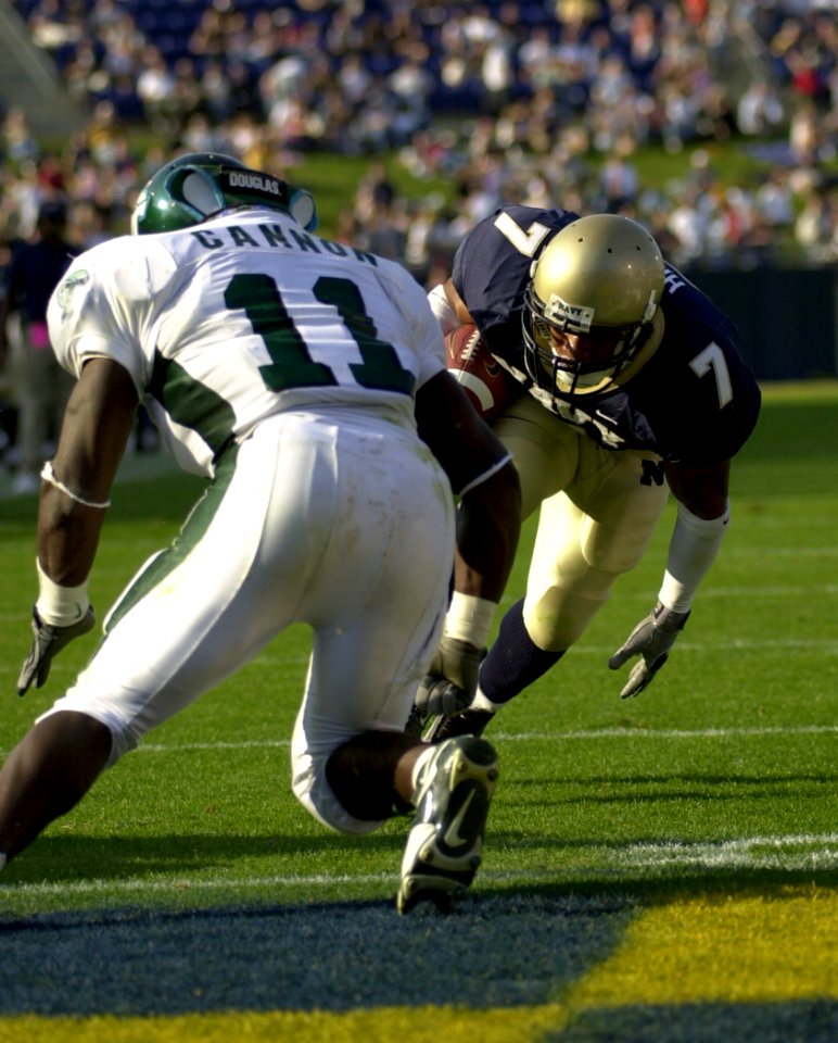 US Navy 031101-N-9693M-702 Navy slot back Trey Hines attempts to elude Tulane's Sean Lucas during Navy's 35-17 victory over Tulane