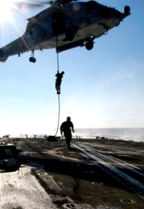 US Navy 031209-N-5319A-004 Sailors from Explosive Ordnance Disposal Mobile Unit Six (EODMU 6) fast rope out of a HH-60H Seahawk helicopter photo