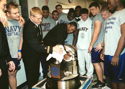 US Navy 031210-N-5390M-001 Navy Football Captains, Midshipman 1st Class Craig Candeto from Orange City, Fla. and Midshipman 1st Class Eddie Carthan from Donalsonville, Ga., dust off the Commander in Chief's Trophy photo