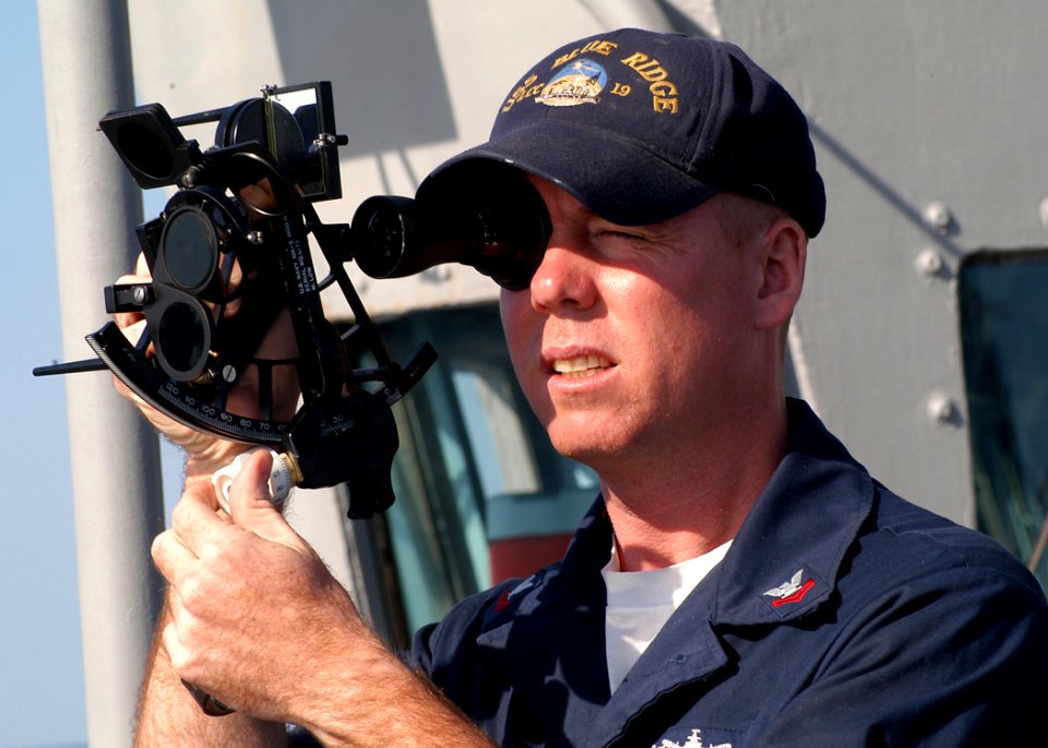 US Navy 031025-N-8955H-005 Quartermaster 2nd Class Martineau, from Ft. Lauderdale, Fla., uses a sextant to shoot the sun line from the port bridge wing of USS Blue Ridge (LCC 19)