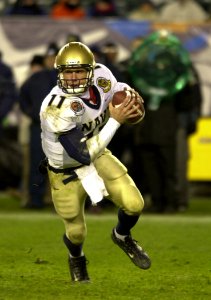 US Navy 031206-N-9693M-504 Navy quarterback Craig Candeto looks for a receiver downfield during the 104th Army Navy Game photo