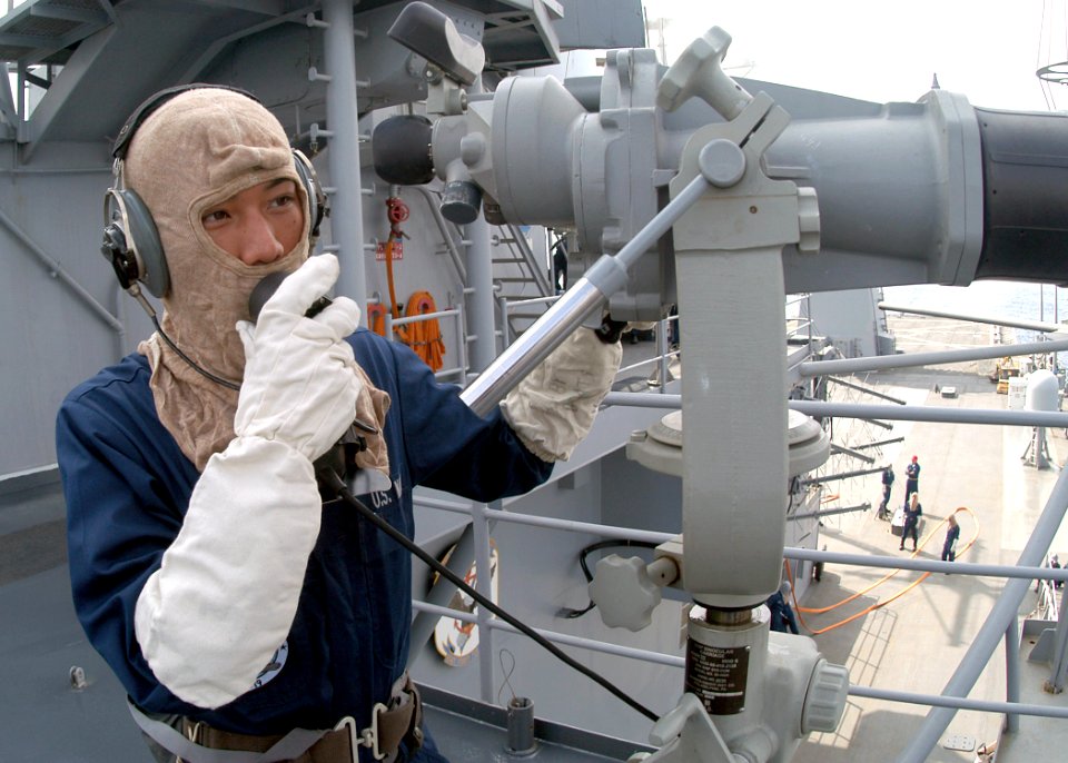 US Navy 031103-N-8955H-002 Signalman 3rd Class Sher Lee, from Green Bay, Wis., makes a report on a sound-powered telephone from a starboard lookout post during a General Quarters training drill aboard USS Blue Ridge (LCC 19)