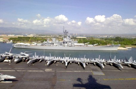 US Navy 031027-N-2385R-004 Crewmembers aboard USS Nimitz (CVN 68) and embarked Carrier Air Wing Eleven (CVW-11), man the rails while passing by the USS Missouri (BB 63) upon entering Pearl Harbor, Hawaii