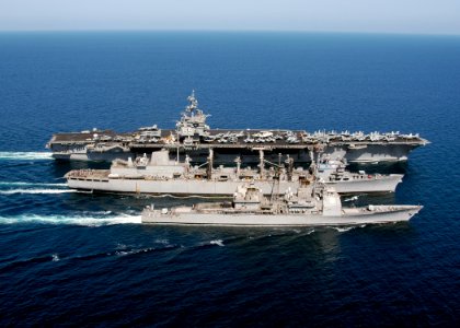 US Navy 031111-N-6259P-002 The guided missile cruiser USS Gettysburg (CG-64) and nuclear-powered aircraft carrier USS Enterprise (CVN-65) alongside the fleet combat support ship USS Detroit (AOE 6)