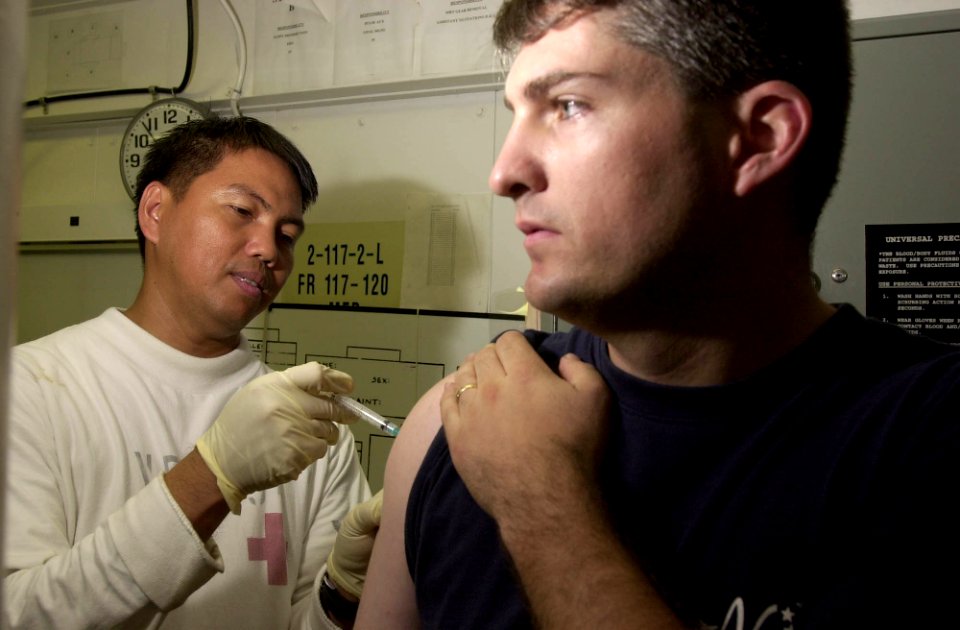 US Navy 031002-N-6536T-005 Hospital Corpsman 1st Class Al Paraguyn from Cebuity, Philippines, assigned to the Mighty Shrikes of Strike Fighter Squadron Nine Four (VFA-94), updates numerous vaccines for fellow squadron members