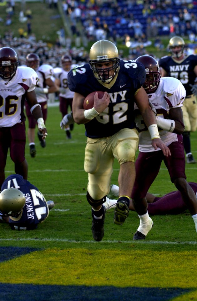 US Navy 031122-N-9693M-014 Navy fullback Kyle Eckel bounds past Central Michigan defenders for a touchdown during the Midshipmen's win over the Chippewas 63-34 in Annpolis, Md