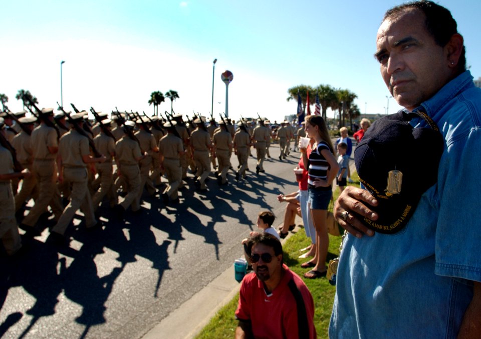 US Navy 031111-N-5862D-169 Spectators, like this Marine veteran, line the street as students assigned to the Officer Candidate School (OCS) march in the Veteran's Day parade at Pensacola Beach, Fla